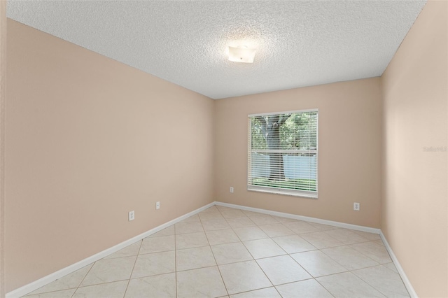 476 Basking Ridge Ct, Ocoee, FL 34761 - empty room featuring a textured ceiling, baseboards, and light tile patterned floors