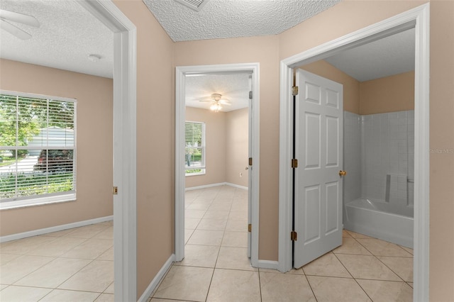 476 Basking Ridge Ct, Ocoee, FL 34761 - hall featuring a textured ceiling, light tile patterned flooring, and baseboards