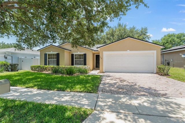 476 Basking Ridge Ct, Ocoee, FL 34761 - ranch-style house with stucco siding, driveway, and a garage