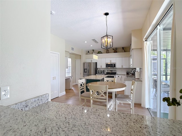 18109 Kara Ct, Tampa, FL 33647 - kitchen with stainless steel appliances, healthy amount of natural light, a chandelier, and a sink