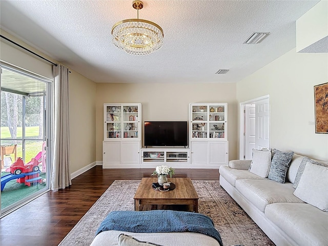18109 Kara Ct, Tampa, FL 33647 - living room with dark wood finished floors, a textured ceiling, a chandelier, and baseboards