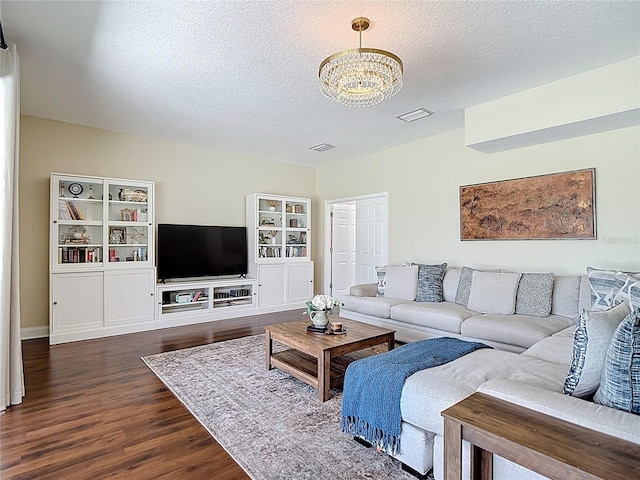 18109 Kara Ct, Tampa, FL 33647 - living room featuring dark wood-type flooring, a chandelier, and a textured ceiling