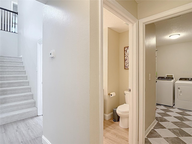 18109 Kara Ct, Tampa, FL 33647 - bathroom featuring washer and clothes dryer, toilet, a textured ceiling, and wood finished floors