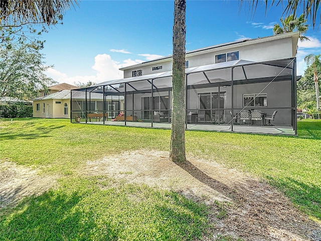 18109 Kara Ct, Tampa, FL 33647 - back of house featuring a yard, stucco siding, and a lanai