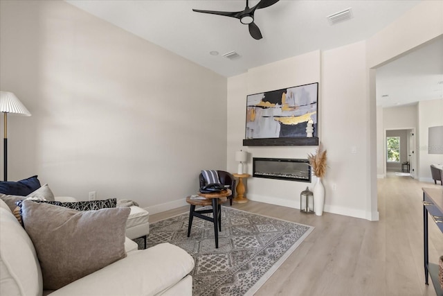 811 E Mcdonald Ave, Eustis, FL 32726 - living room with a ceiling fan, wood finished floors, and baseboards