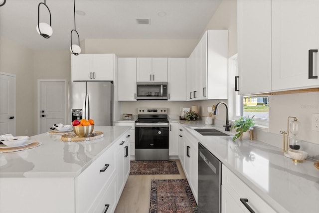 811 E Mcdonald Ave, Eustis, FL 32726 - kitchen with appliances with stainless steel finishes, a sink, white cabinetry, and light wood-style flooring