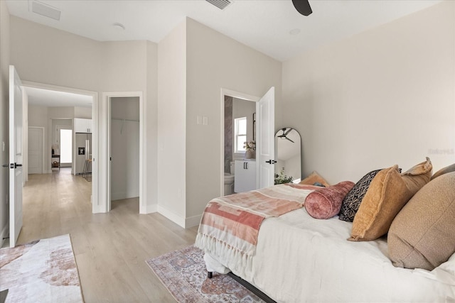 811 E Mcdonald Ave, Eustis, FL 32726 - bedroom with light wood finished floors, baseboards, ensuite bath, a ceiling fan, and a closet
