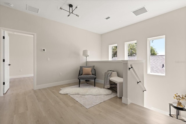 811 E Mcdonald Ave, Eustis, FL 32726 - sitting room with an upstairs landing, light wood-style floors, and baseboards