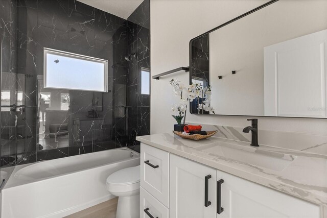 811 E Mcdonald Ave, Eustis, FL 32726 - bathroom featuring vanity, bathing tub / shower combination, and toilet