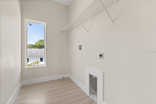 811 E Mcdonald Ave, Eustis, FL 32726 - laundry room featuring hookup for a washing machine, electric dryer hookup, light wood-style flooring, and baseboards