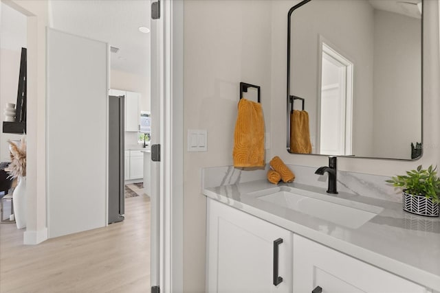 811 E Mcdonald Ave, Eustis, FL 32726 - bathroom featuring wood finished floors and vanity