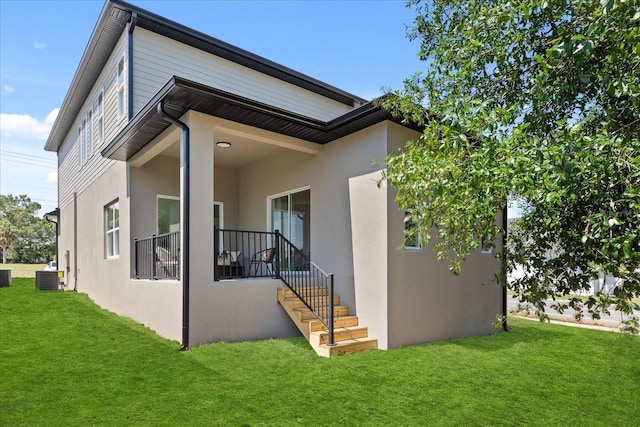811 E Mcdonald Ave, Eustis, FL 32726 - view of home's exterior featuring a lawn, stucco siding, and central AC unit