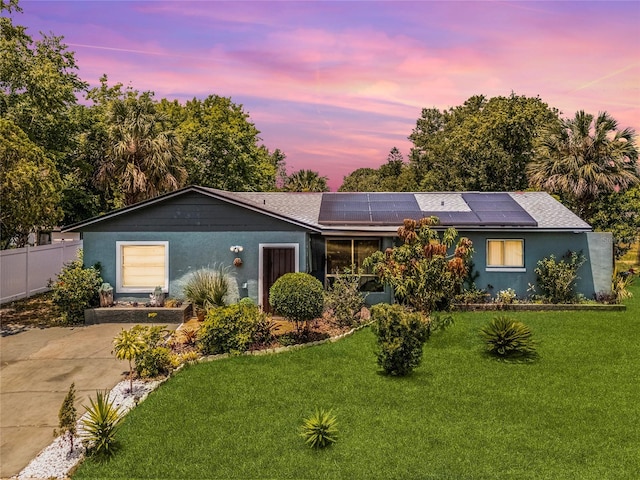 1872 Wayside Dr, Orlando, FL 32818 - ranch-style home with roof mounted solar panels, roof with shingles, and stucco siding
