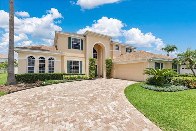 4221 Kezar Ct, Belle Isle, FL 32812 - mediterranean / spanish-style house with stucco siding, an attached garage, decorative driveway, and a front lawn