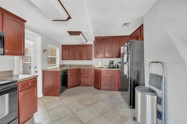232 E Grant St, Orlando, FL 32806 - kitchen featuring black appliances, light tile patterned floors, light countertops, and a sink