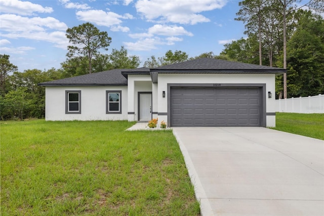 10218 N Langdon Rd, Citrus Springs, FL 34434 - prairie-style house featuring stucco siding, an attached garage, concrete driveway, and roof with shingles