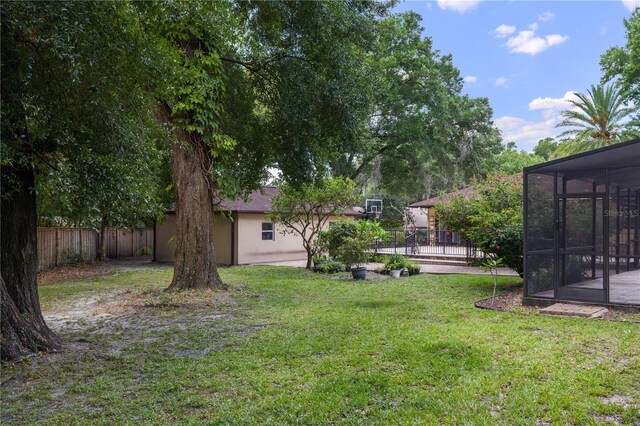 2009 Woody Dr, Windermere, FL 34786 - view of yard with a sunroom