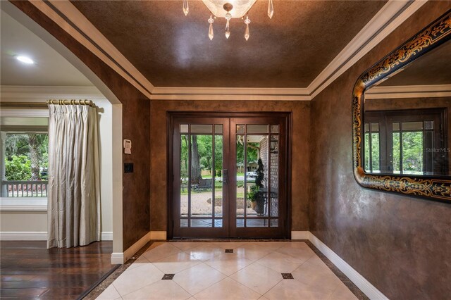 2009 Woody Dr, Windermere, FL 34786 - entrance foyer with french doors, healthy amount of natural light, baseboards, and crown molding