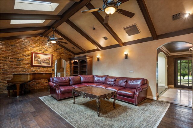 2009 Woody Dr, Windermere, FL 34786 - living room featuring a ceiling fan, arched walkways, wood-type flooring, brick wall, and baseboards