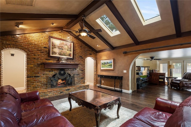 2009 Woody Dr, Windermere, FL 34786 - living area with arched walkways, a ceiling fan, wood finished floors, beamed ceiling, and high vaulted ceiling