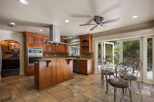 2009 Woody Dr, Windermere, FL 34786 - kitchen featuring island exhaust hood, ornamental molding, open shelves, stainless steel appliances, and a breakfast bar
