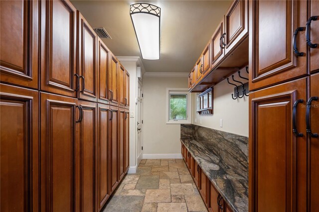2009 Woody Dr, Windermere, FL 34786 - mudroom with stone tile floors, baseboards, and crown molding