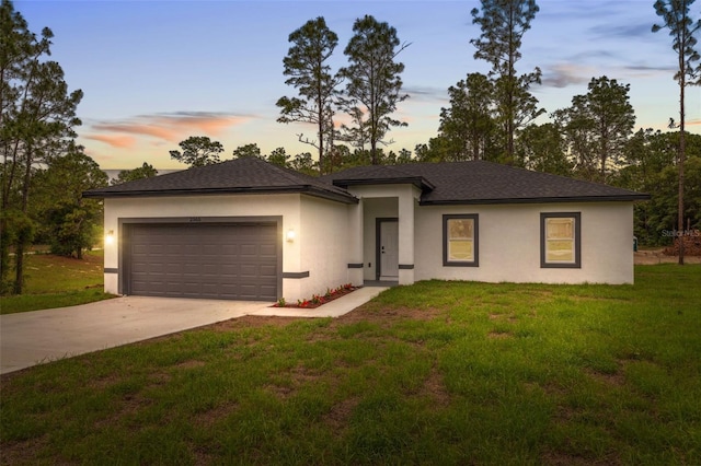 2565 W Laredo Dr, Citrus Springs, FL 34433 - prairie-style home with an attached garage, stucco siding, concrete driveway, and a front lawn