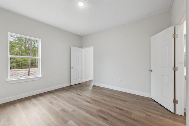 2565 W Laredo Dr, Citrus Springs, FL 34433 - unfurnished bedroom featuring light wood finished floors and baseboards