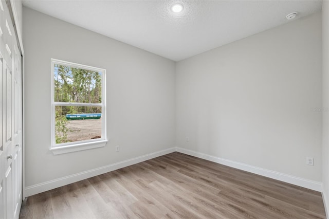 2565 W Laredo Dr, Citrus Springs, FL 34433 - spare room featuring light wood-style floors, baseboards, and a smoke detector