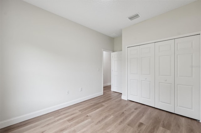 2565 W Laredo Dr, Citrus Springs, FL 34433 - unfurnished bedroom featuring light wood-style floors, baseboards, and a closet