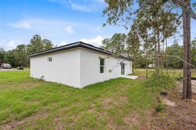 2565 W Laredo Dr, Citrus Springs, FL 34433 - view of property exterior with stucco siding and a yard