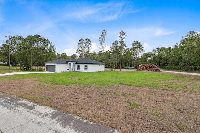 2565 W Laredo Dr, Citrus Springs, FL 34433 - view of front of property with driveway, an attached garage, a front yard, and view of scattered trees
