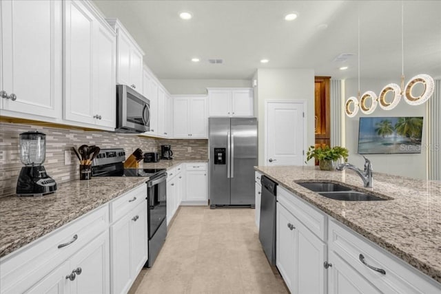 4310 Lana Ave, Davenport, FL 33897 - kitchen featuring stainless steel appliances, a sink, white cabinets, tasteful backsplash, and recessed lighting