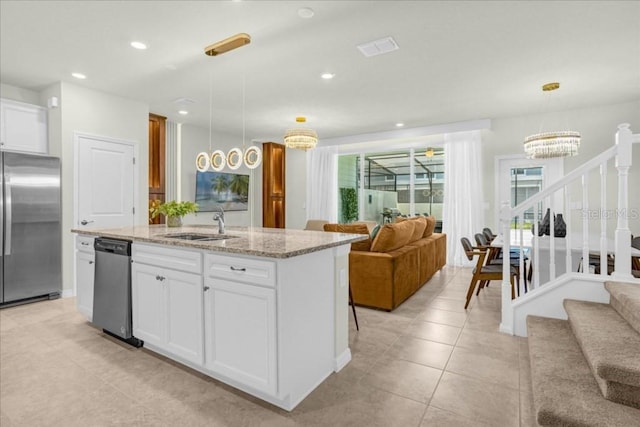 4310 Lana Ave, Davenport, FL 33897 - kitchen featuring stainless steel appliances, open floor plan, a sink, a center island with sink, and recessed lighting