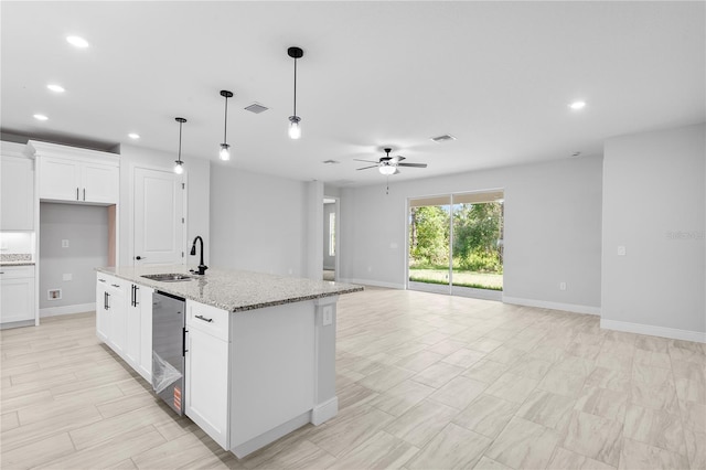 30369 Apricot Ave, Eustis, FL 32736 - kitchen with open floor plan, a ceiling fan, recessed lighting, hanging light fixtures, and light stone countertops