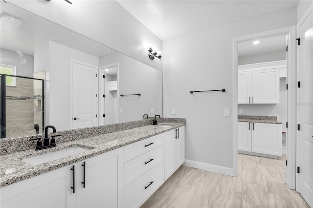 30369 Apricot Ave, Eustis, FL 32736 - bathroom with double vanity, a stall shower, and a textured ceiling