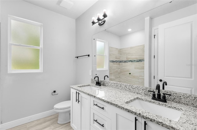 30369 Apricot Ave, Eustis, FL 32736 - bathroom featuring double vanity, a tile shower, and wood finished floors