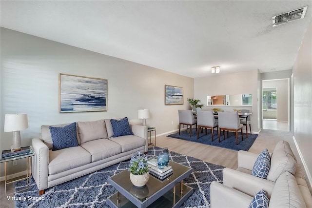 1230 Americana Pl, Orlando, FL 32807 - living room with baseboards and wood finished floors