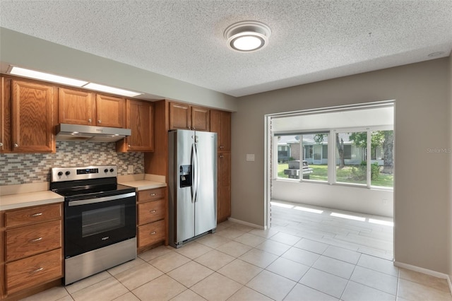 1230 Americana Pl, Orlando, FL 32807 - kitchen featuring appliances with stainless steel finishes, under cabinet range hood, brown cabinetry, light countertops, and decorative backsplash