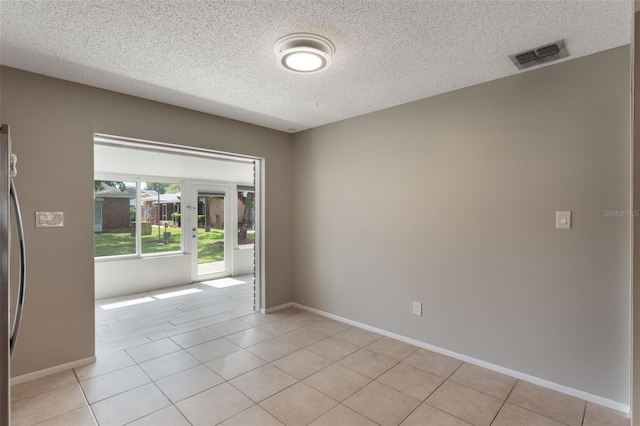 1230 Americana Pl, Orlando, FL 32807 - spare room featuring a textured ceiling, light tile patterned floors, and baseboards