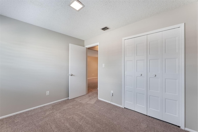 1230 Americana Pl, Orlando, FL 32807 - unfurnished bedroom featuring carpet flooring, a textured ceiling, baseboards, and a closet