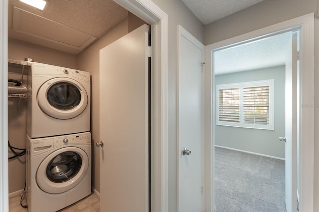 1230 Americana Pl, Orlando, FL 32807 - laundry room featuring estacked washer and dryer, baseboards, a textured ceiling, and carpet floors