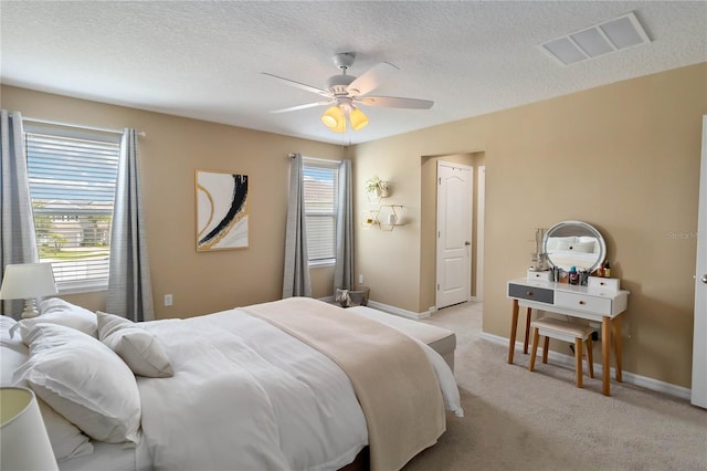 3883 Crawley Down Loop, Sanford, FL 32773 - bedroom with light carpet, a textured ceiling, baseboards, and ceiling fan