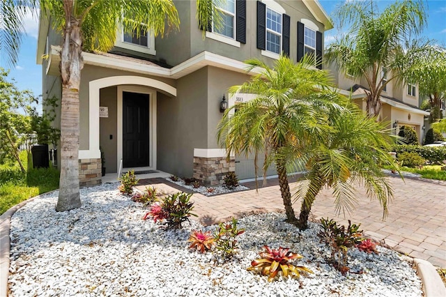 3883 Crawley Down Loop, Sanford, FL 32773 - doorway to property with stucco siding and stone siding