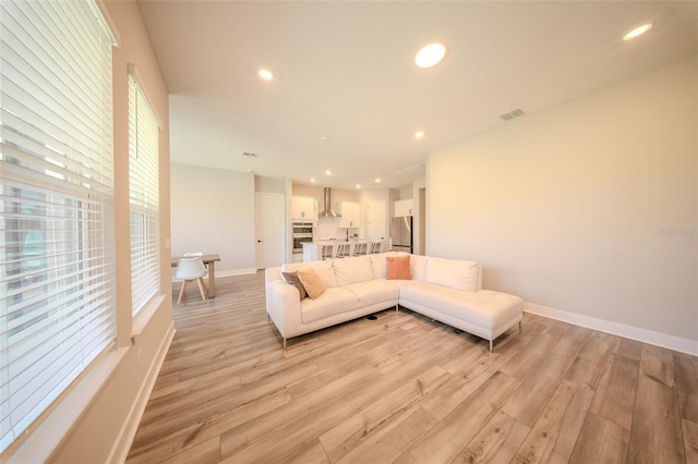 16055 Silver Brook Way, Winter Garden, FL 34787 - living area featuring light wood finished floors, recessed lighting, and baseboards