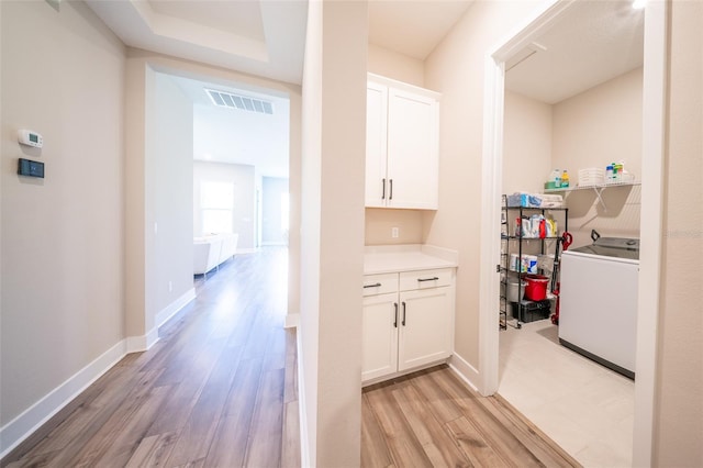 16055 Silver Brook Way, Winter Garden, FL 34787 - washroom with washer / dryer, light wood-type flooring, and baseboards