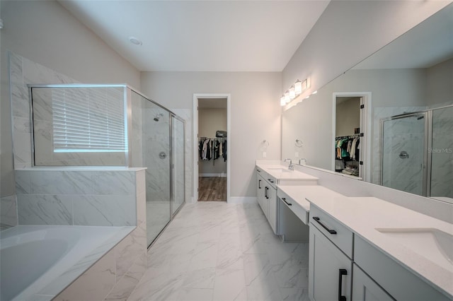 16055 Silver Brook Way, Winter Garden, FL 34787 - bathroom with double vanity, marble look tile flooring, a spacious closet, and a shower stall
