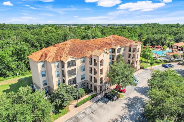 1375 Tuscana Ln Unit 1102, Davenport, FL 33896 - drone / aerial view of a forest and a pool area
