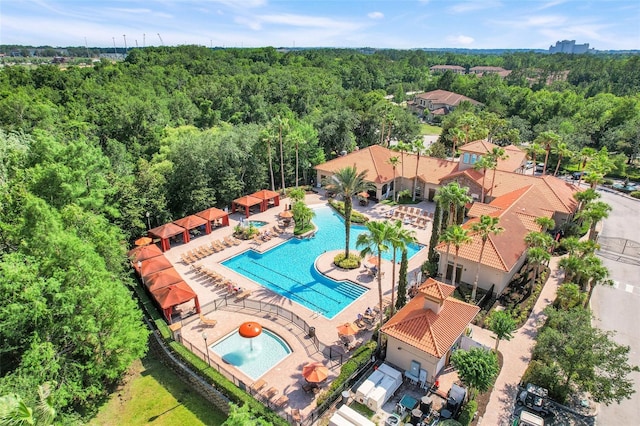 1375 Tuscana Ln Unit 1102, Davenport, FL 33896 - drone / aerial view of a pool area and a heavily wooded area