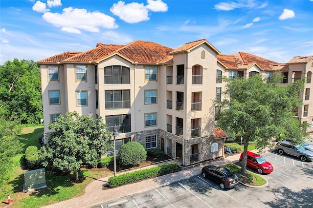 1375 Tuscana Ln Unit 1102, Davenport, FL 33896 - view of apartment building / complex featuring uncovered parking